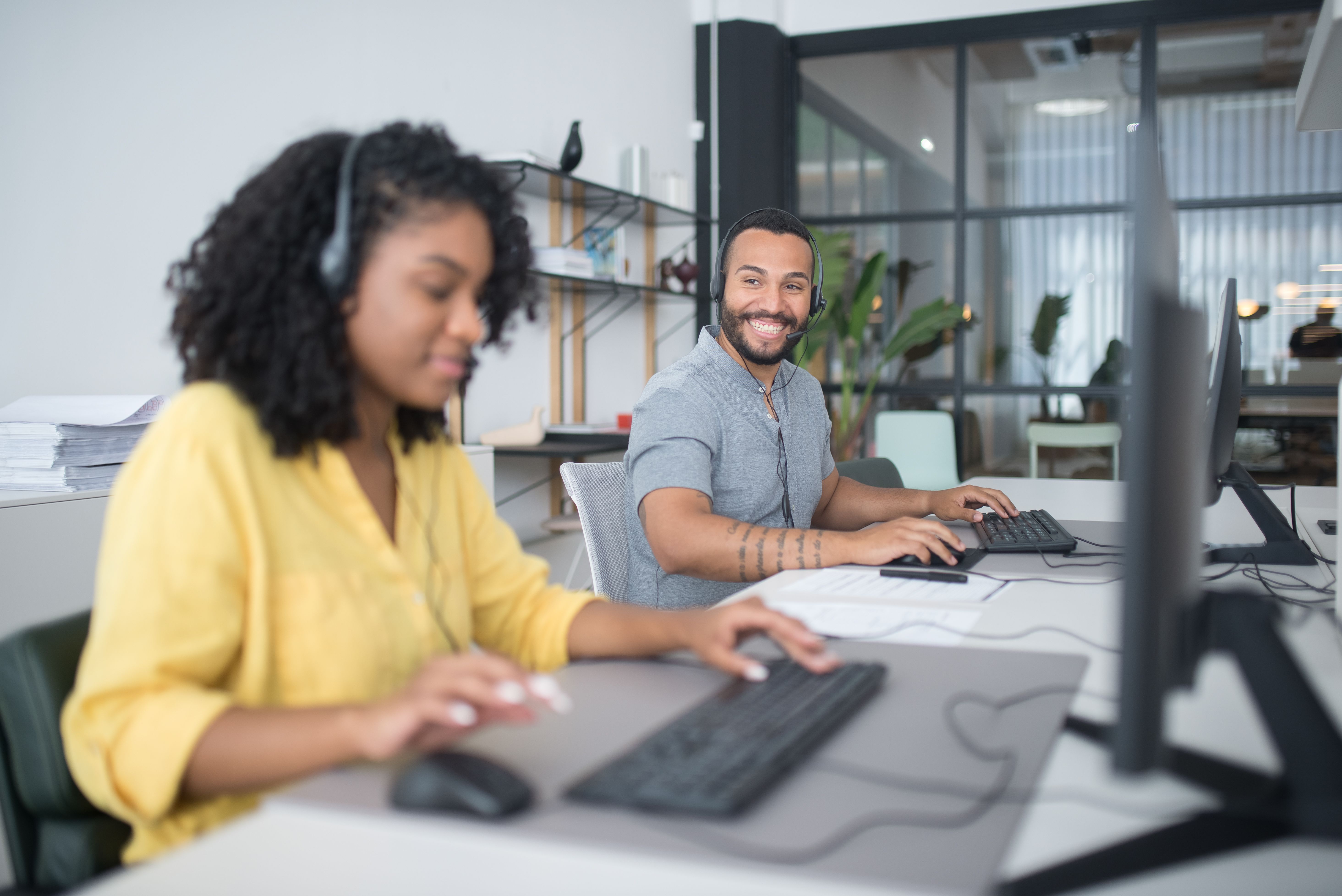 Customer support team with headsets representing the AI front counter and service coordination workflow
