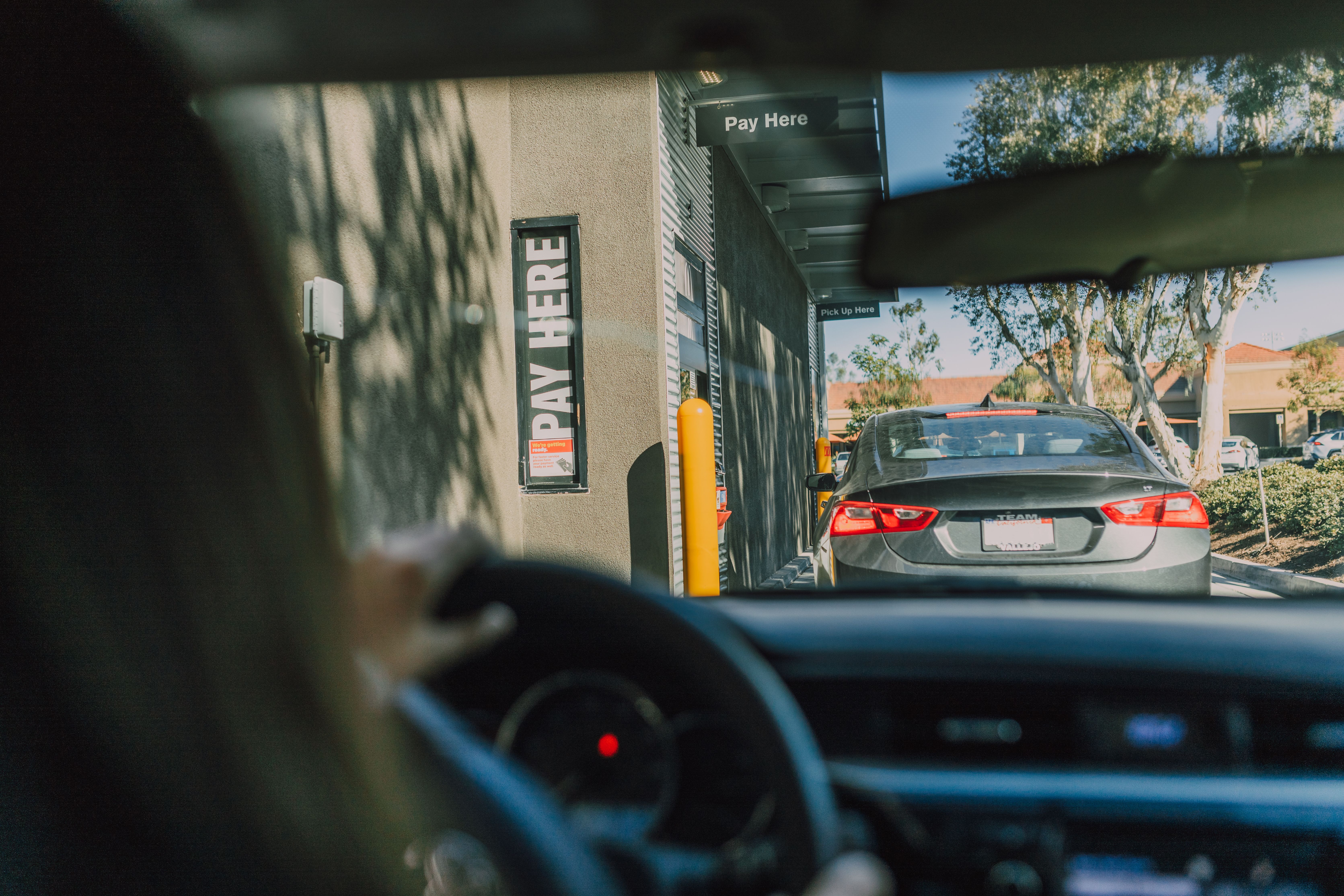 Drive-through ordering scene representing AI-driven lane control and throughput optimization