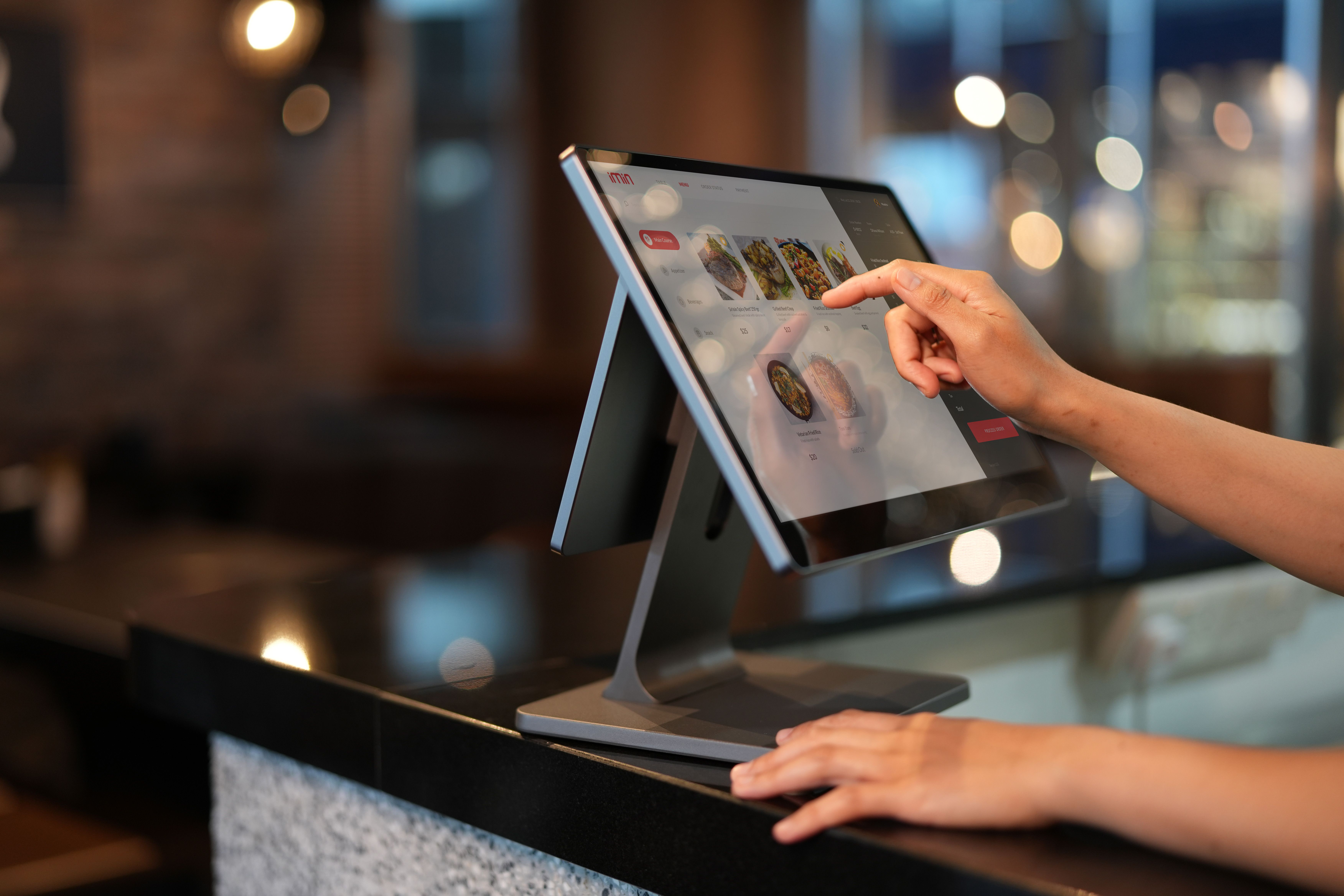 Restaurant POS touchscreen representing benchmarked operational data collection